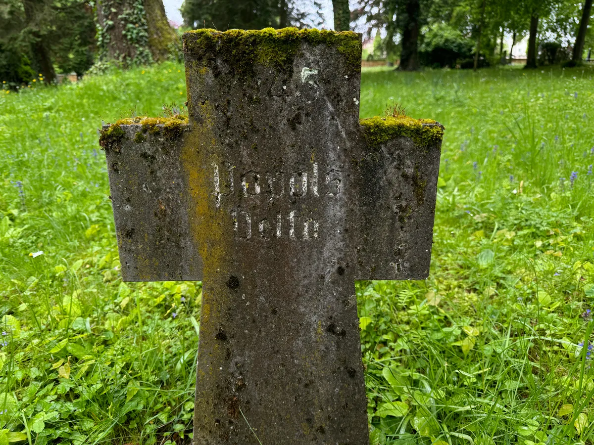 Kamienny krzyż Velty Popols.
Napis: „1945 / Popols / Velta”